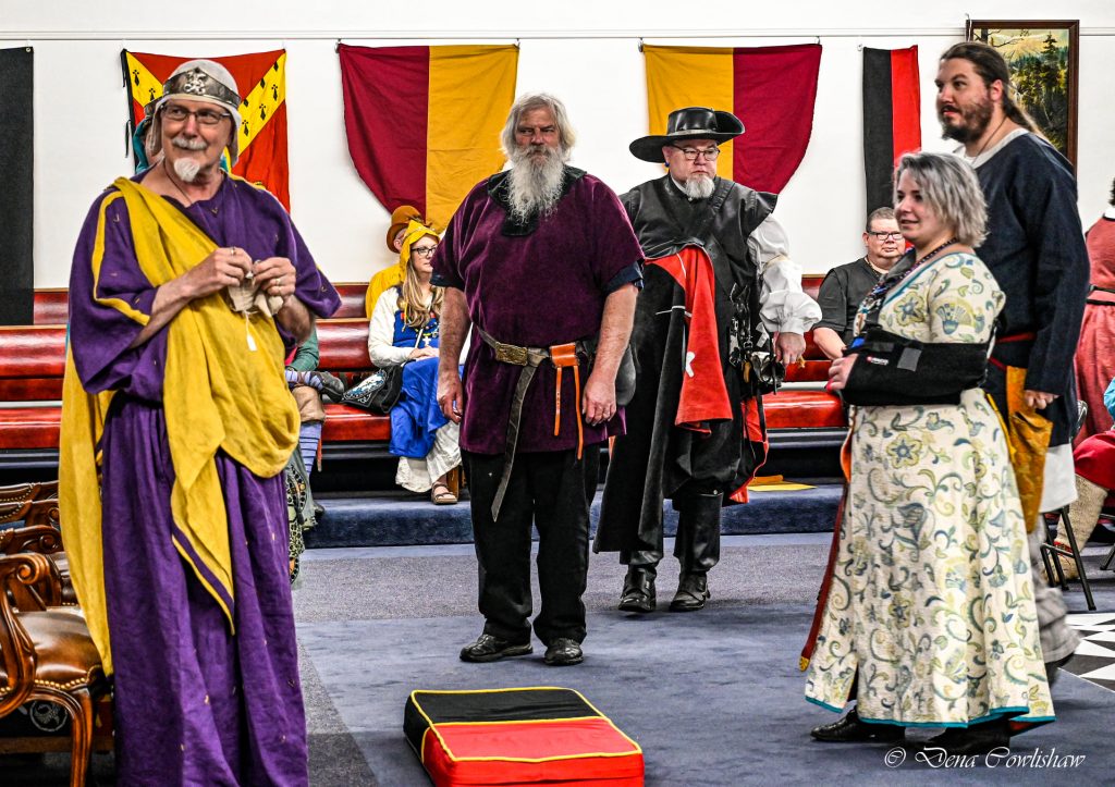 Dragon's Laire Court at "Son of Candlemas" 2022, with Baron Arion the Wanderer on the left and several members of the Dragon's Laire Populace nearby.